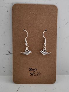 These earrings are lovely to wear with anything. Don you know someone that loves birds?  Beautiful small bird earrings  Lovely present for someone special or for yourself. 3cm earring with 7mm zinc alloy charm. Made with hypoallergenic silver plated hooks. Size may vary due to being handmade by myself. Don't forget to follow Knots at No.29 on Instagram for all the latest news and updates. Silver Bird-shaped Earrings Gift, Silver Bird-shaped Earrings For Gift, Nickel-free Bird-shaped Earrings For Gifts, Bird-shaped Jewelry Set With Matching Earrings, Dangle Earrings With Bird Design For Gift, Bird Earring, Birds Beautiful, Love Bird, Earring Gift