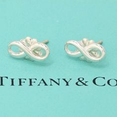 I Ship Within 1 Business Day Authentic Includes Tiffany Box And Pouch Description & Details Tiffany Infinity Is A Powerful Symbol Of Continuous Connection, Energy And Vitality. The Sleek Lines Of These Sterling Silver Earrings Catch The Light To Create Added Dimension. Sterling Silver Mini Product Number:60013 Silver Infinity Earrings For Formal Events, Silver Infinity Earrings For Formal Occasions, Elegant Sterling Silver Infinity Earrings, Tiffany Box, Stud Earrings Silver, Mini Studs, Tiffany Jewelry, Daisy Earrings, Knot Earrings