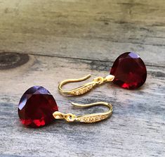 "Burgundy Garnet gold pave earrings. Heart cut garnets. Red stone jewelry. Red garnet dangles. Dark red garnet drops. Junuary birthstone. Available in 3 finishes. Length 1 1/4\". Dark red faceted gems are 14x14 mm as photo are sold, 19x14 mm and 13x17 mm stones are available. These beautiful earrings will arrive in a jewelry box ready for gift giving." Red Faceted Garnet Earrings, Red Heart Cut Elegant Earrings, Elegant Red Heart Cut Earrings, Red Faceted Earrings For Anniversary, Elegant Burgundy Jewelry For Valentine's Day, Red Stone Jewelry, Pave Earrings, Garnet And Gold, Faceted Gems