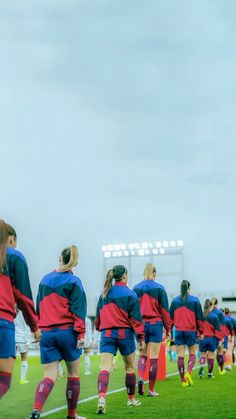 the women's soccer team is warming up on the field for their match against each other