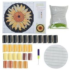 the complete kit for making cross stitch sunflowers is shown in yellow and orange