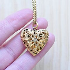 This necklace is made from a gold plated locket charm. The locket is in a shape of a simple heart and opens so you can put something special inside. The front of the locket is an intricate filigree design with cut outs. The locket hangs from a gold stainless steel chain. You can choose the style and length of the chain. Please choose the length you would like the necklace in. Please choose the chain style you would like your pendant on. Please note that all necklaces are handmade and may differ Gold Open Heart Charms Jewelry, Gold Open Heart Charm Jewelry, Gold Heart-shaped Jewelry With Charms, Wedding Heart Pendant Gold Plated Locket Necklace, Rose Gold Heart Charm Pendant Locket Necklace, Rose Gold Heart Charm Locket Necklace, Gold-plated Heart Pendant Locket Necklace, Rose Gold Heart Pendant Locket Necklaces, Rose Gold Heart Pendant Locket Necklace