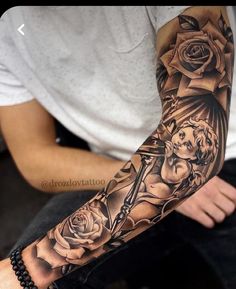 a man with a cross and roses on his arm