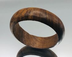 *About me: vintage wooden bangle. I started my life on the beautiful isle of Ibiza, long before it became the sunny party club capital. That said I do like a good party and my rich deep golden brown colouring looks good in any weather, just don't get me wet!  *Size: Approx. length 20cm / 8 inches, width 2.2cm *Weight: Approx. 34.8 grams *Age: Born 1973 *Condition: Good vintage condition, I have a little scrape on my inner from when I was made *Gift boxed to your door ** A vintage item that has b Wooden Bangle, Golden Brown, Vintage Jewellery, Best Part Of Me, About Me, All Pictures, Ibiza, Etsy Vintage, Picture Video