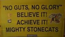 a yellow sign that says no guts, no glory believe it achieve it mighty stones