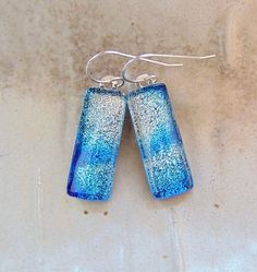 "The stones in these beautiful earrings measure approximately 1\" by 3/8\".  They are hung with sterling silver French wire hooks and hang approximately 1 3/8\".  The dichroic glass in these earrings shimmer with silver and blue on black colored glass.  They are capped with clear and full fused for strength and depth. Thank you for looking in my shop.  All of my pendants and earrings will arrive in a gift box.  I do my best to accurately photograph my work so you will be happy with your purchase. Dichroic Glass changes colors with different lighting and different angles, therefore making it difficult to photograph. You must see my dichroic pieces in hand to appreciate the color and depth of each piece. They are so much more beautiful in person, than in the photographsyou must see to apprec Sterling Silver Blue French Hook Earrings, French Hook Dangle Earrings For Gift, Blue Sterling Silver Earrings With French Hook, Silver Linear Earrings With French Hook Gift, Long Drop French Hook Earrings For Gift, Dichroic Glass Pendant, French Wire, Necklace Blue, Dichroic Glass