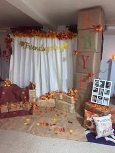 a decorated stage with fall leaves on the ground