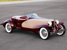 an antique car is parked on the street