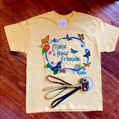 Adorable Girl Scout Tee Shirt With The Classic Make New Friends Phrase On The Front Of The Shirt . Soft Yellow/Butterflies/Flowers. 50 Cotton/50 Poly Blend . Machine Wash Cold .Also A Set Of 4 Head Bands And 12 Pony Tail Bands With Girl Scout Logos And Hearts . Girl Scout Logo, Yellow Butterflies, Butterflies Flowers, Head Bands, Yellow Butterfly, Soft Yellow, Girl Scout, Make New Friends, Girl Scouts