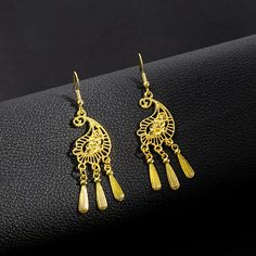 Material: Alloy Style: Ethnic Style Elegant Tassel Chandelier Earrings For Festivals, Elegant Festival Chandelier Earrings With Tassels, Traditional Gold Tassel Festival Earrings, Traditional Gold Tassel Earrings For Festivals, Elegant Festival Chandelier Earrings With Latkans, Gold Elegant Tassel Earrings For Festival, Elegant Gold Tassel Earrings For Festival, Bohemian Gold Earrings With Peacock Design, Bohemian Gold Chandelier Earrings With Tassels