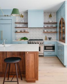 a kitchen with blue cabinets and an island