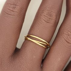 This interlocking ring features a versatile and stylish design, making it perfect for stacking or wearing on its own. Made from high-quality gold, this ring is a timeless accent piece that adds a touch of elegance to any outfit. A must-have for any jewelry collection. 14k gold filled interlocking fidget ring with 3 bands Adjustable Recycled Gold Stackable Rings, Fine Jewelry Adjustable Stackable Rings With Open Band, Stackable 14k Gold Bypass Ring With Open Band, Adjustable Open Band Stackable Rings, 14k Gold Stackable Bypass Ring With Open Band, Adjustable Yellow Gold Stackable Rings With Simple Design, Adjustable 14k Gold Double Band Ring, Adjustable Double Band 14k Gold Ring, Chic Yellow Gold Open Band Jewelry