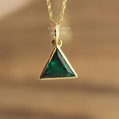 Lab Emerald Trilliant Necklace - Bezel Set Gemstone Pendant for a Modern Look. Elegant Lab Emerald Pendant - Bezel Set Trilliant Necklace for a Touch of Luxury. Gemstone ✦ 𝗟𝗮𝗯 𝗚𝗿𝗼𝘄𝗻 / 𝗖𝗿𝗲𝗮𝘁𝗲𝗱 𝗘𝗺𝗲𝗿𝗮𝗹𝗱 - 𝗠𝗮𝗻 - 𝗠𝗮𝗱𝗲 ✦ Trilliant / Triangle Step Cut -  ✦ Color -Green ✦ Excellent / Very Good Cut - Size (mm) : 4 mm (approx) ✦ Setting :  Bezel ✦ Bail - 3 mm Diameter Inside ✦ READY TO SHIP - GIFTS ✦ ( ONLY CHARM - PENDANT - SELECT CHAIN as per order ) To view more designs. ht Trillion Cut May Birthstone Jewelry Gift, Trillion Cut Jewelry With Bezel Setting As Gift, Trillion Cut Bezel Set Jewelry For Gifts, Elegant May Birthstone Jewelry With Trillion Cut, Elegant May Birthstone Trillion Cut Jewelry, Elegant Trillion Cut May Birthstone Jewelry, Uncommon Gifts, Minimalist Jewellery, May Birthday