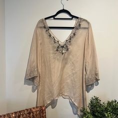 This Boho Shirt Is In Great Condition. The Beading Around The Neckline Is Perfectly Intact With No Snags. The Sheer Material Is A Cream/Taupe Color. The Fit Of This Shirt Is Effortlessly Flowly And Perfect For Layering Or To Stand In Its Own. Sleeves Are 3/4 Length And The Sides Of The Shirt Extend Down To Add To The Flow Of The Shirt. #Buckle #Gimmicks #Nwot #Nwt #Boho #Henley #Waffleknit #Knit #Longsleeve #Tee #Shirt #Top #Blouse Elegant Embroidered Beach Tops, Beaded V-neck Tops For Summer, Summer Beaded V-neck Tops, Summer V-neck Beaded Top, Beaded V-neck Top For The Beach, Casual Beaded V-neck Tops, Bohemian Beaded Tops For Beach, Elegant Beach Tops With 3/4 Sleeves, Elegant Embellished Tops For The Beach