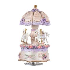 a lamp that is sitting on top of a stand with flowers and horses around it