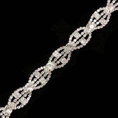 "Elegant crystal rhinestone trimming made with high quality rhinestones set on metal setting. Perfect for wedding or formal occasions. For best application, hand-sewing is recommended. Item Code: RT-018 Width: 1\" Sold by the yard (1 yard = 36 inches) All items are available to ship from our NYC store. We ship both US and International. No returns or exchanges." Sparkling Metal Rhinestone Necklace For Wedding, Diamond Rhinestone Necklace For Wedding, Sparkling Rhinestone Diamond Necklace For Weddings, Diamond Rhinestone Necklace For Wedding, Sparkling, Wedding Diamond Rhinestone Necklace, Formal Silver Crystal Bridal Belt, Silver Rhinestone Bridal Belt For Formal Occasions, Silver Rhinestone Necklace For Wedding With Sparkling Stones, Dazzling Rhinestone Necklace For Wedding