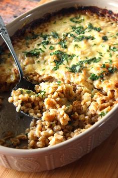 a casserole dish filled with rice and spinach garnished with parsley