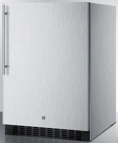 a stainless steel freezer sitting on top of a metal counter next to a white wall