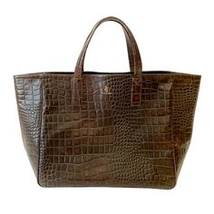 The Faux-Coco "croc-effect" Weekender is handcrafted in California of rich, 100% Italian, vegetable tanned cow leather debossed with an exquisite Nile Croc pattern. The roomy, luxurious, natural suede leather interior allows for great versatility in its use. Inspired by our insatiable appetite for exploration and travel, this bag is the ultimate in our series of #weekenderbags perfect for your next getaway. #stickandball #leathertote #bag #earthtones Classic Leather Shoulder Bag With Crocodile Pattern, Leather Shoulder Bag With Crocodile Pattern For Shopping, Luxury Leather Shoulder Bag With Textured Finish, Classic Brown Bag With Crocodile Pattern, Luxury Brown Crocodile Pattern Bag, Luxury Leather Bag With Textured Finish, Everyday Rectangular Textured Bag, Rectangular Textured Everyday Bag, Luxury Brown Crocodile Pattern Shoulder Bag