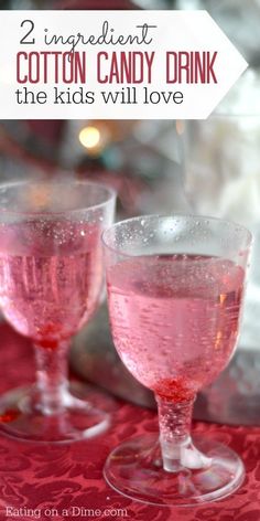 two glasses filled with pink liquid sitting on top of a table