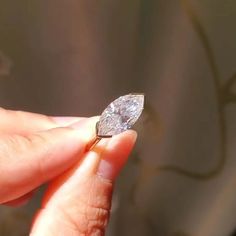 a person holding a diamond in their hand