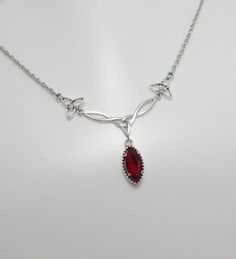 This is a new handmade necklace. It is made with antiqued silver plated Celtic knots, accented with a high quality DARK RUBY RED/GARNET glass jewel that sparkles like crystal. Decorated portion is 2 1/2" wide and 1 1/4" tall in the center. Necklace is adjustable 15-18" with a lobster clasp and chain extender. If you would like a different length, please send us a message.Matching earrings and headpiece are listed in our store in a variety of stone colors. If you don't see items with a color you Luxury Red Necklaces For Rituals, Red Gem Jewelry, Ruby Red Necklace, Red Stone Necklace, Celtic Goddess, Formal Jewelry, Celtic Knots, Red Necklace, Red Jewelry