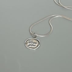 ▪︎ ONE sterling silver round charm with LOVE YOU inscribed on it. ▪︎ Size: 13 x 15 mm ( 17mm with hoop) Weight: 1.3 gm ▪︎ This is a multi functional charm and can be used with neck chains, ear hoops, bracelets, anklets, key chains etc. ▪︎ This pendant is handmade with hypoallergenic sterling silver, and is nickel free. Comes with a 925 mark for authenticity. ▪︎ Please note: Price listed is for ONE charm. This pendant comes WITHOUT the chain, however, you can add a snake neck chain, bracelet chai Yin Yang Bracelet, Yin Yang Charm, Wanderlust Jewelry, Silver Wings, Gift Love, Neck Chain, Love Charms, Silver Pendant Necklace, Key Chains