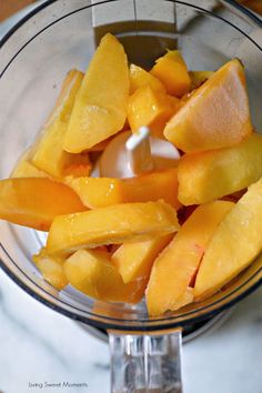 sliced mangoes in a food processor ready to be blended