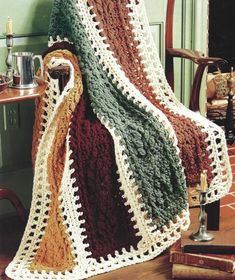 a crocheted blanket sitting on top of a chair