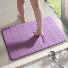 a person standing on top of a bath mat