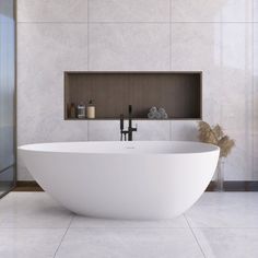 a large white bathtub sitting in the middle of a bathroom next to a walk in shower