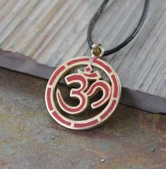 A cool chunky 1 1/2 inch OM in a circle design Handmade in Kathmandu Nepal, Brass and copal chips hand set. Cord and chains sold separately. Pendant pictured with 1 Meter Waxed Cord. Om Pendant, A Circle, Circle Design, Nepal, Washer Necklace, Wax, Coral, Chips, Brass