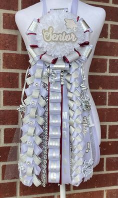 a mannequin is adorned with ribbons and jewels