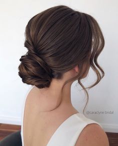 a woman with her hair in a low bun