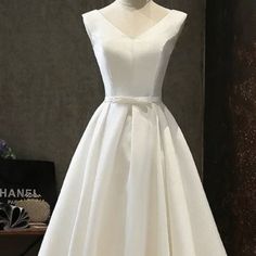 This Beautiful New White Dress With A V-Neck, Small Bow At Waist And A Button And Lace Up Back. This Dress Is Perfect For Any Special Occasion. Fully Lined. Size 4 With Built In Bra Cup. Tea-Length. Never Worn/Tags Are Still On. Has A Satin Sheen To It. White A-line V-neck Wedding Dress, White V-neck Midi Dress For Wedding, A-line V-neck Dress For Wedding, Elegant White A-line V-neck Dress, White Midi Length V-neck Dress For Formal Occasion, White Sleeveless V-neck Dress For Formal Occasions, White Midi V-neck Dress For Formal Occasions, Formal White Sleeveless V-neck Dress, Classic V-neck Wedding Dress