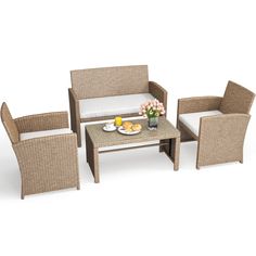 a set of wicker furniture with coffee table, chairs and vase on the table