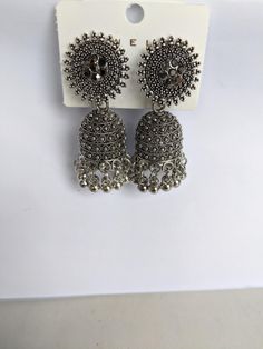 Indian style jhumka earrings. Vintage style. Costume jewellery. Chandbali Earrings With Latkans, Bollywood Style Intricate Design Jhumkas, Heavy Drop Earrings Jhumkas, Heavy Drop Jhumkas, Navratri Drop Earrings Jhumkas, Silver Jhumkas For Navratri Party, Silver Bollywood Style Drop Jhumkas, Navratri Drop Danglers, Round Tilla Jhumkas