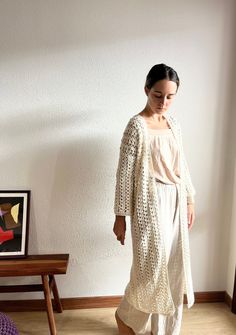 This long cardigan, has a gorgeous crochet stitch 100% handmade. This cotton kimono cardigan has a beautifull open closure. This beige crochet cover up is made with hight quality cotton yarn, anti allergic and super super soft. This amazing maxi cardigan is the gargment that you would want wear it forever! Perfect to wear it with dresses or with a jean! Super comfortable, stylish and versatile! WHICH IS MY SIZE? This long cardigan is available in different sizes.  In order to know which is the perfect size for you, you just have to measure your chest . Below, you can find the measurements referred to every size: Measurements referring to the chest contour:  Size S: 80 cm / 32 in. Size M: 90 cm / 35 in. Size L: 100 cm / 39 in. If you can't find your size or you are not sure about the size, Bohemian Oversized Cardigan For Vacation, Oversized Bohemian Cardigan For Vacation, Beige Bohemian Open Knit Crochet Dress, Bohemian Long Sleeve Crochet Lace Cardigan, Bohemian Crochet Lace Cardigan For Fall, Fall Open Knit Crochet Beach Dress, Bohemian Open Front Open Knit Cardigan, Bohemian Open Knit Cardigan With Open Front, Bohemian Open Knit Open Front Cardigan