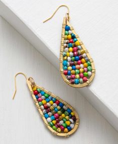 Fun, miniature handcrafted paper beads in a classic teardrop shape add a pop of color to any outfit. Gift Teardrop Earrings With Colorful Beads, Multicolor Wire Wrapped Beaded Earrings, Handmade Teardrop Earrings For Festival, Festival Teardrop Earrings With Ear Wire, Artisan Colorful Beaded Teardrop Earrings, Artisan Teardrop Beaded Earrings With Dangling Beads, Gold Teardrop Earrings With Colorful Beads, Multicolor Beaded Teardrop Earrings, Bohemian Teardrop Earrings With Colorful Beads