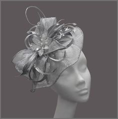 Ladies metallic silver disc fascinator (hatinator) with sinamay loops, feathers and a gorgeous crystal flower centre. Made on a headband. This design can be made to order, please contact us for details. Perfect for a tea party, wedding (mother of the bride), race day or for a special occasion. Designs can be made to order in a range of different colours or styles, see our colour chart: www.jacquivaledesigns.com/colour_chart.html Please contact me if you would like a design in a different colour. Elegant Silver Hat For Evening, Adjustable Silver Headband For Evening, Silver Adjustable Evening Headpieces, Elegant Silver Hat For Kentucky Derby, Silver Headband For Evening, Adjustable Silver Party Hat, Silver Headband Fascinator For Party, Silver Evening Fascinator For Kentucky Derby, Silver Fascinator For Evening At Kentucky Derby