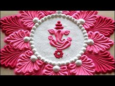 a pink and white doily with an ornate design