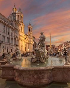 a fountain in the middle of a city square