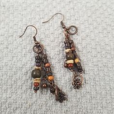 Light and dark toned wood bead dangle earrings with copper chain and charm dangle on French hook ear wires. Drop length is 2.75 inches Wood always imparts a warm feeling and these earrings with the copper accents give an added warm feeling.  They can be worn in the Fall and all year long to accessorize all styles and color of clothing. Knitting Moodboard, Poo Poo, Bead Dangle Earrings, Copper Accents, Jewelry Picture, Pretty Jewelry, Funky Jewelry, Light And Dark, Copper Chain