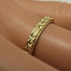 a close up of a gold ring on a person's arm with it's hand