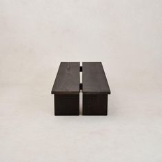 two wooden tables sitting on top of each other