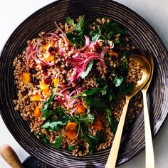 a salad with spinach, onions and carrots in a bowl