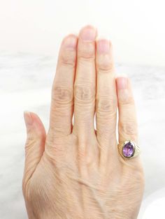 This Vintage 14k Amethyst Ring has clean, elegant lines for a classic look. The setting is 14k yellow gold and showcases a medium tone amethyst stone. The setting has wonderful Art Deco style at the shoulders. The amethyst measures approximately 7.2 x 9.8 x 5.85 mm or approximately 2.2 carats by measurement. The ring is circa the 1930's and under magnification some scratches and abrasions are visible on the stone commensurate with wear. However, this would not be noticeable when the ring is worn Purple Stone Ring, Amethyst Ring Vintage, Purple Stone Rings, Gold Amethyst Ring, Kids Rings, Blue Stone Ring, Right Hand Rings, Ring Art Deco, Purple Band