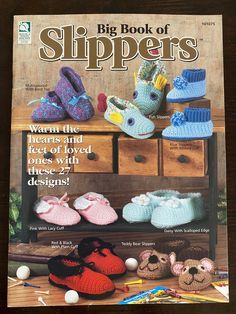 a book with crocheted slippers sitting on top of a wooden table next to other items