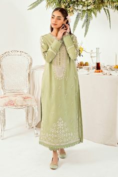 Introducing "Mint Majesty," a captivating ensemble in our summer collection. This pastel green outfit exudes a sense of freshness, adorned with intricate chikankari embroidery delicately tracing the neckline, hemline (daman), and sleeves. Paired with tailored trouser pants, it stands as a class apart, epitomizing effortless sophistication and timeless charm. Step into the realm of elegance with "Mint Majesty," where every detail speaks of refined grace and unmatched allure. Green Chikankari Embroidery Salwar Kameez For Transitional Season, Elegant Pista Green Traditional Wear With Naqshi, Traditional Green Dress With Naqshi Detailing, Traditional Green Naqshi Dress, Spring Anarkali Set With Cutwork, Green Anarkali With Naqshi Detailing, Green Traditional Wear For Spring Wedding, Pista Green Traditional Wear With Intricate Embroidery For Spring, Elegant Pista Green Kurta For Transitional Season