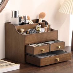 a wooden desk with drawers and makeup on it